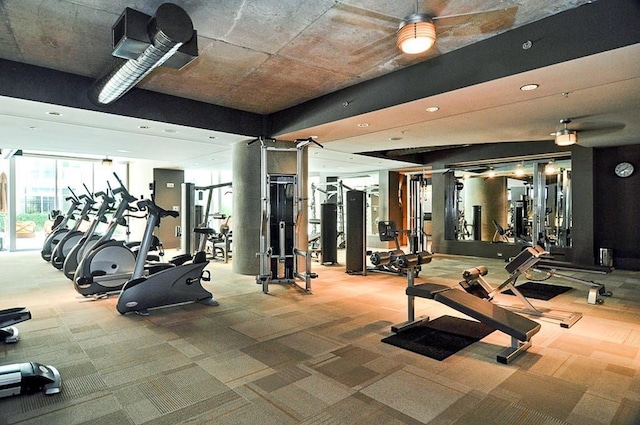 workout area featuring ceiling fan and expansive windows