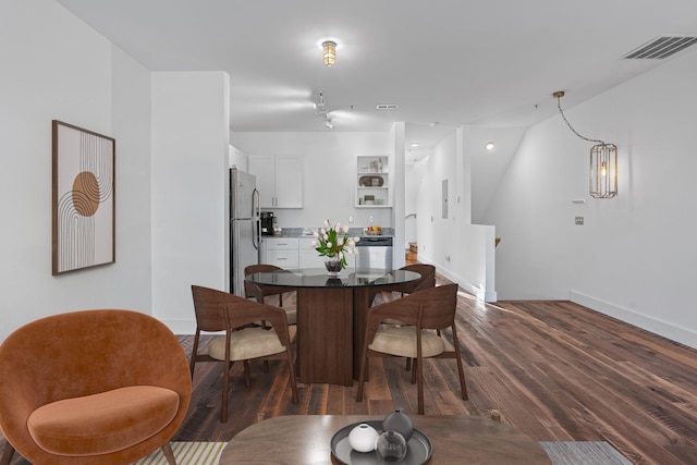 dining area featuring dark wood-type flooring