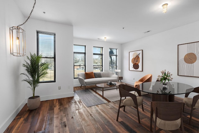 living room featuring a healthy amount of sunlight and dark hardwood / wood-style flooring