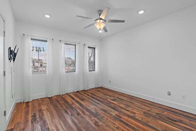 empty room with ceiling fan and dark wood-type flooring