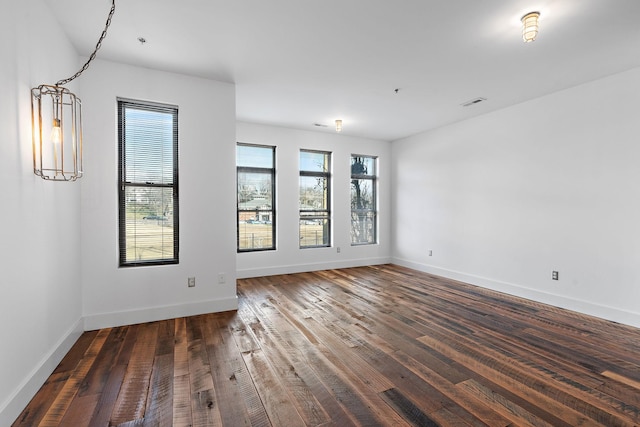 unfurnished room featuring dark hardwood / wood-style floors