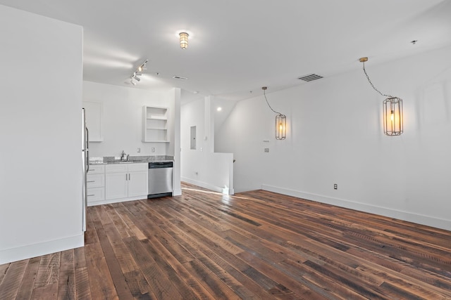 unfurnished living room with dark hardwood / wood-style flooring, electric panel, and sink