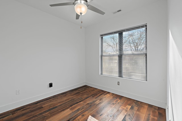 empty room with dark hardwood / wood-style floors and ceiling fan