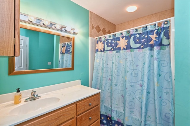 bathroom with curtained shower and vanity