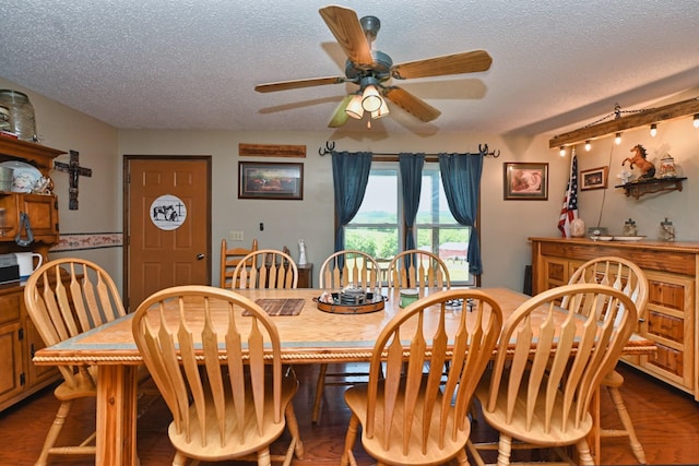 dining area featuring a textured ceiling, ceiling fan, and wood-type flooring