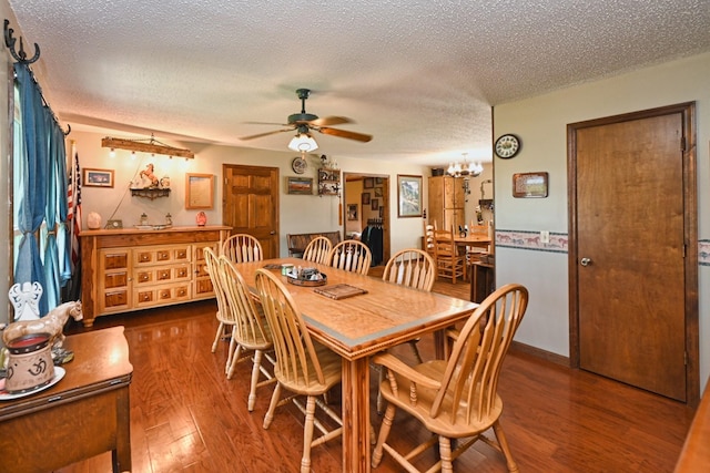 dining space featuring a textured ceiling, dark hardwood / wood-style flooring, and ceiling fan with notable chandelier