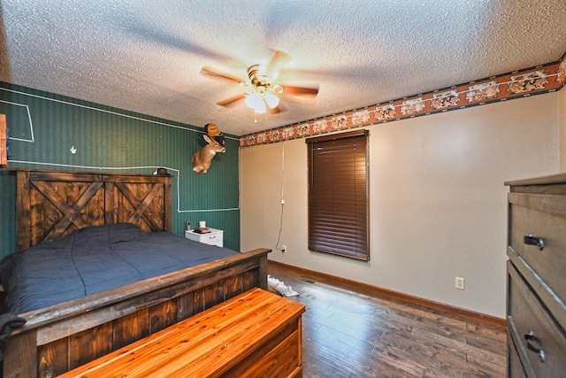 unfurnished bedroom with ceiling fan, dark hardwood / wood-style flooring, and a textured ceiling