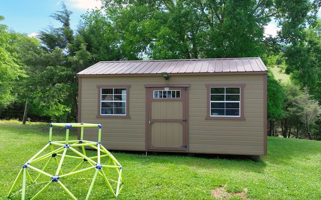 view of outbuilding featuring a lawn