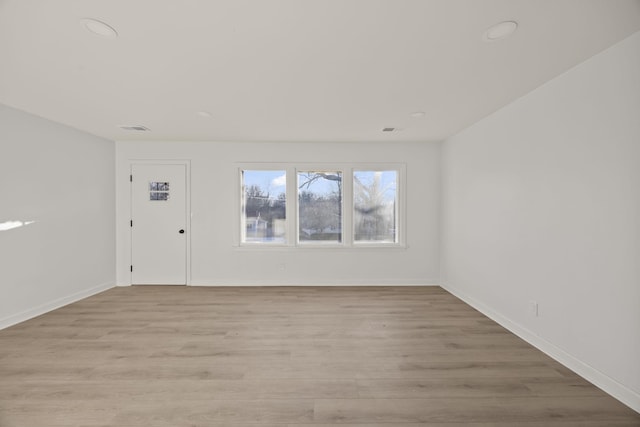 unfurnished room with light wood-type flooring