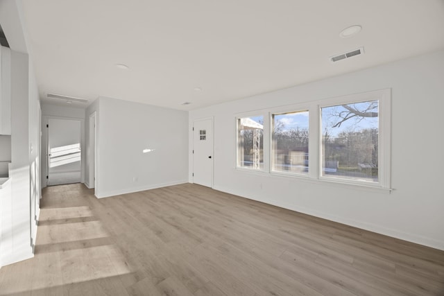 unfurnished living room featuring light wood-type flooring