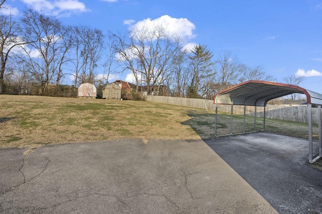 view of yard with a shed and a carport