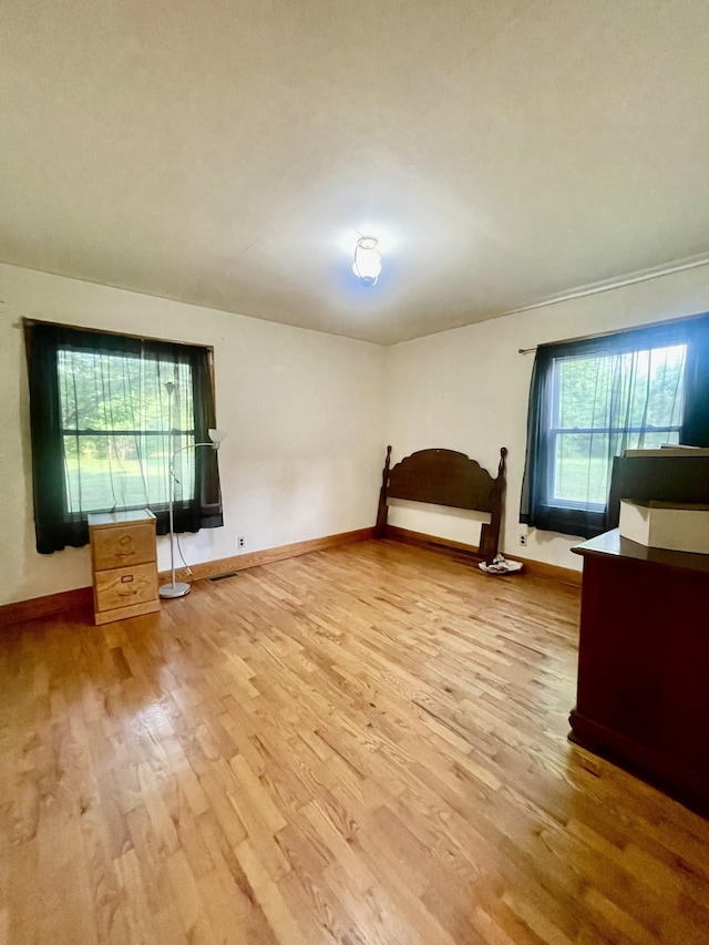 unfurnished bedroom with wood-type flooring