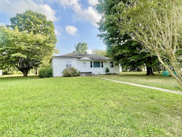 back of house with a yard