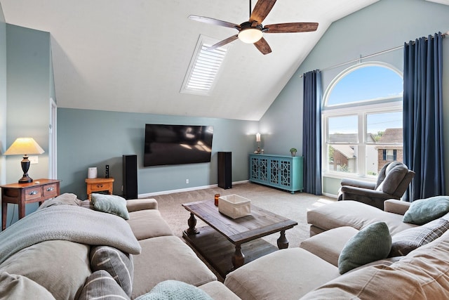 carpeted living room with ceiling fan and vaulted ceiling