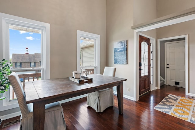 dining area with dark hardwood / wood-style flooring