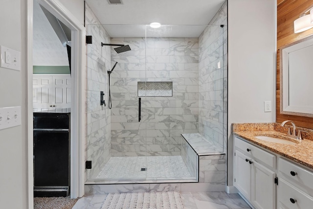 bathroom with vanity and a shower with door