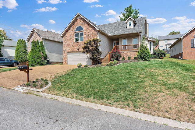 view of property featuring a porch, a garage, and a front lawn