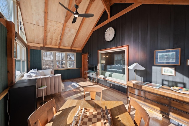 sunroom / solarium featuring vaulted ceiling with beams, ceiling fan, and wooden ceiling