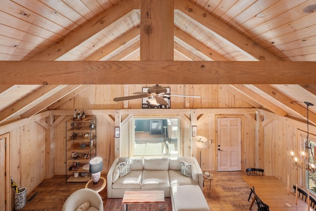 bonus room with ceiling fan with notable chandelier, wood-type flooring, lofted ceiling with beams, and wood walls