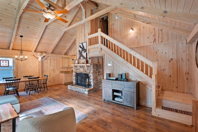 living room with dark hardwood / wood-style flooring, wood ceiling, ceiling fan with notable chandelier, beam ceiling, and high vaulted ceiling