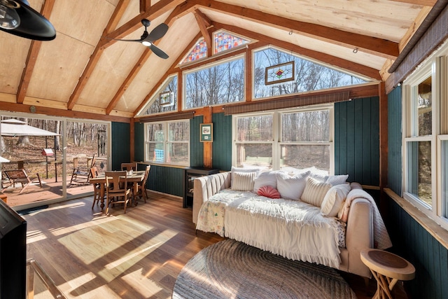 sunroom with vaulted ceiling with beams, ceiling fan, and plenty of natural light