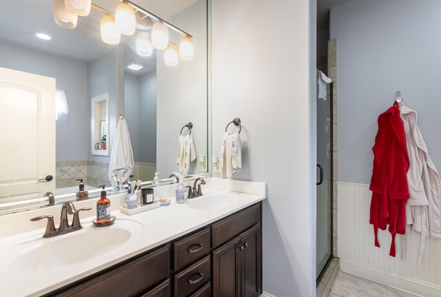 bathroom with tile patterned floors, vanity, and walk in shower