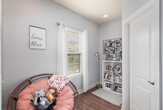 interior space with dark hardwood / wood-style flooring and multiple windows