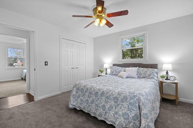 carpeted bedroom with ceiling fan and a closet