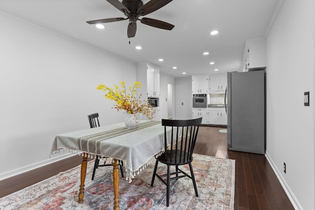 dining room with crown molding, ceiling fan, and dark hardwood / wood-style floors