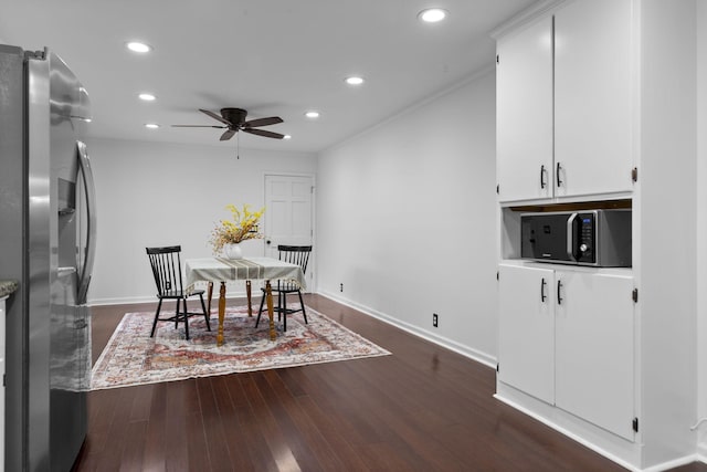 dining area with ceiling fan and dark hardwood / wood-style floors