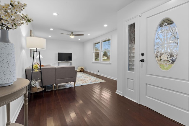 foyer entrance with ceiling fan and dark hardwood / wood-style flooring