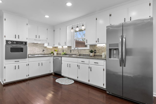 kitchen featuring white cabinets, appliances with stainless steel finishes, dark hardwood / wood-style floors, and sink