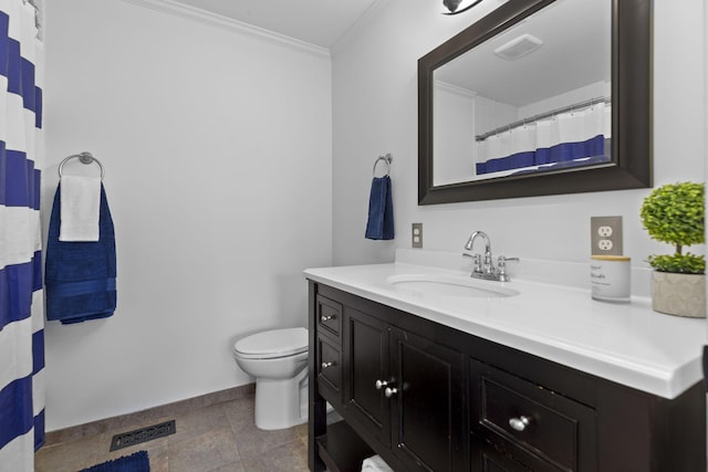 bathroom with toilet, vanity, and ornamental molding