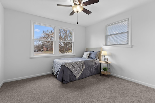 bedroom featuring ceiling fan and carpet