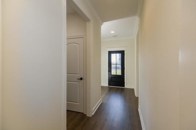 foyer entrance with dark hardwood / wood-style flooring and crown molding