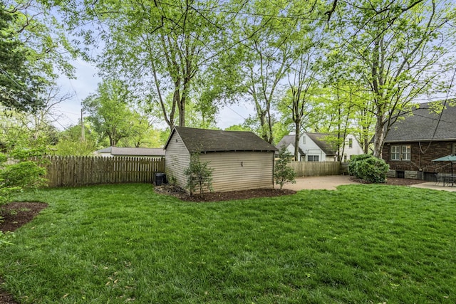 view of yard featuring a storage unit, a patio area, and central air condition unit