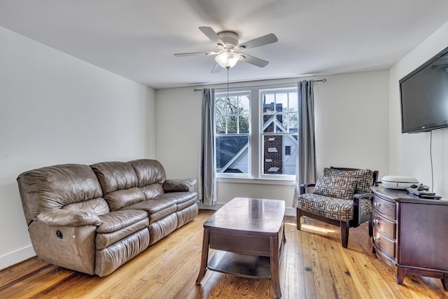 living room with ceiling fan and light hardwood / wood-style flooring