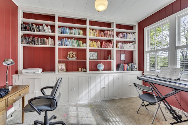 office area featuring wood walls, carpet floors, ornamental molding, and built in features