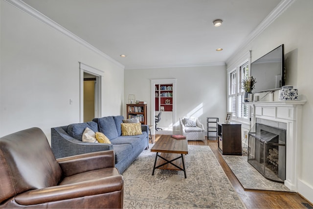 living room with hardwood / wood-style floors and crown molding