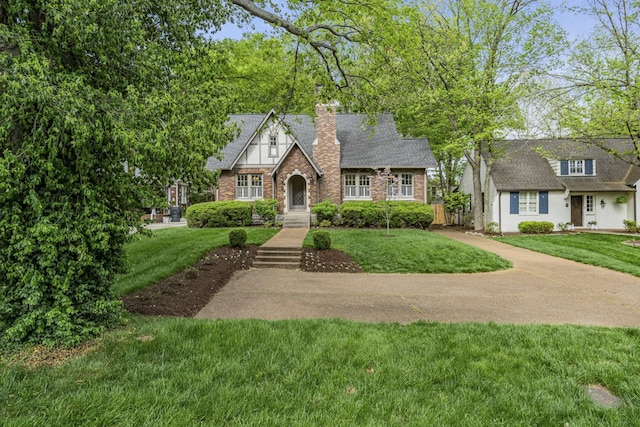 english style home with a front yard