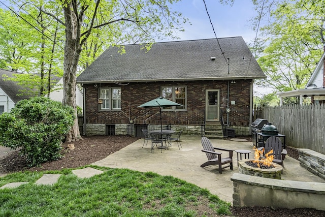 rear view of house featuring a fire pit and a patio area