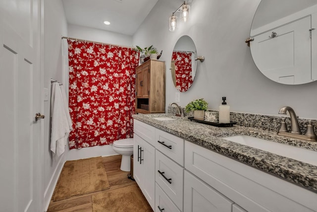 full bathroom with shower / tub combo with curtain, vanity, and toilet