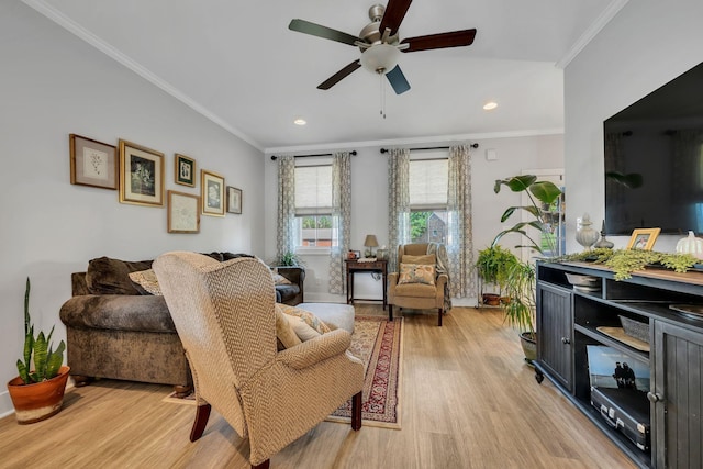 living room with crown molding, light hardwood / wood-style flooring, and ceiling fan