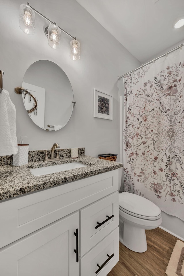 full bathroom with vanity, toilet, wood-type flooring, and shower / bath combo with shower curtain