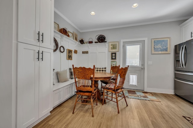 dining room featuring light hardwood / wood-style floors and ornamental molding