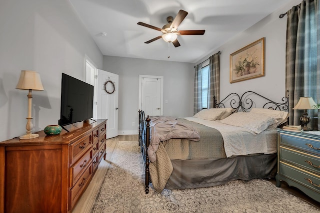 bedroom with multiple windows, light hardwood / wood-style flooring, and ceiling fan