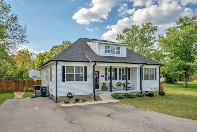 view of front of property with covered porch and a front yard