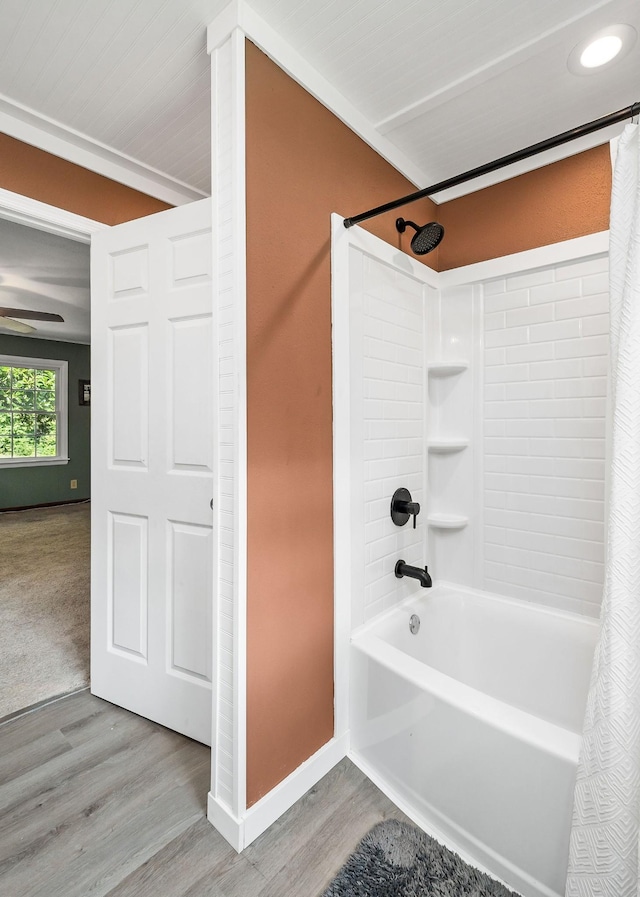 bathroom featuring wood-type flooring and shower / tub combo