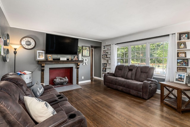 living room featuring dark wood-type flooring and a brick fireplace