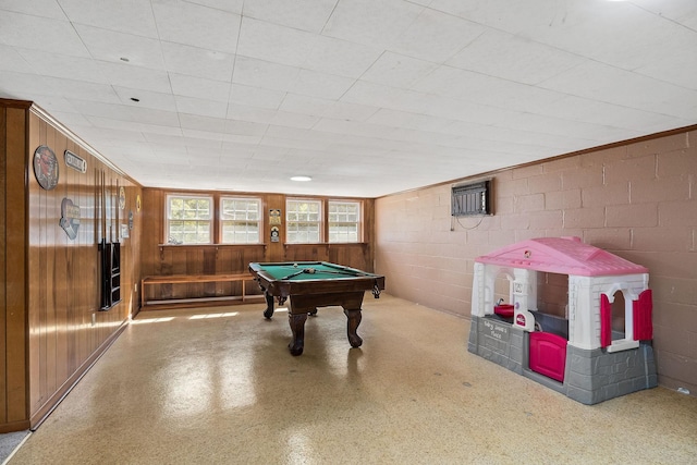 game room with an AC wall unit, wood walls, and billiards